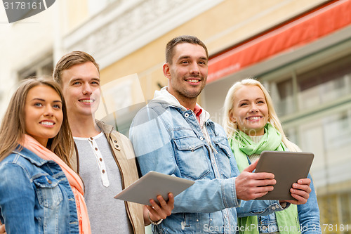 Image of group of smiling friends with tablet pc computers