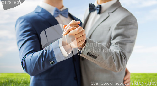 Image of close up of happy male gay couple dancing