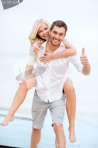 Image of couple having fun on the beach