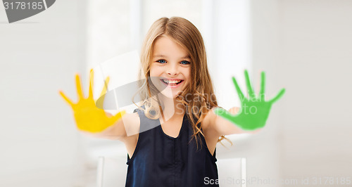 Image of girl showing painted hands