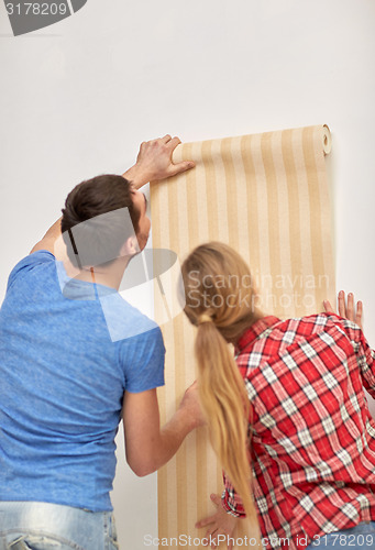 Image of close up of couple holding wallpaper
