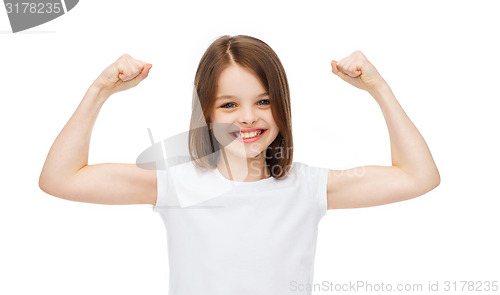 Image of little girl in blank white t-shirt showing muscles