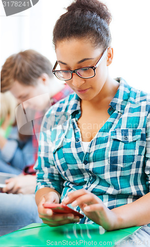 Image of student girl with smartphone at school