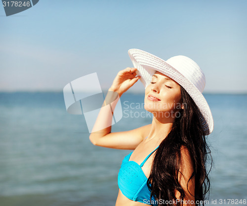 Image of girl in bikini standing on the beach