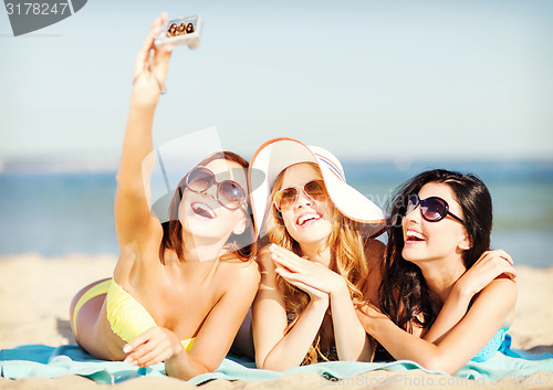 Image of girls taking self photo on the beach