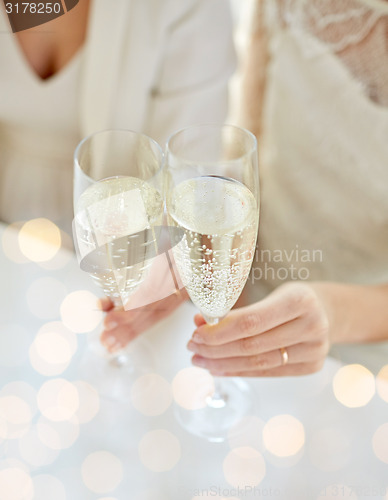 Image of close up of lesbian couple with champagne glasses