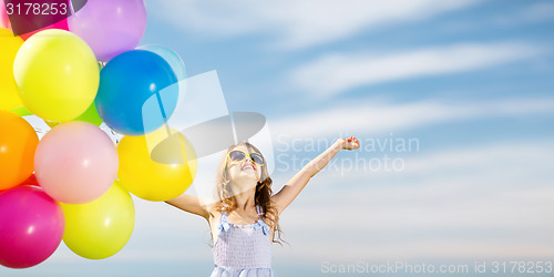Image of happy girl with colorful balloons
