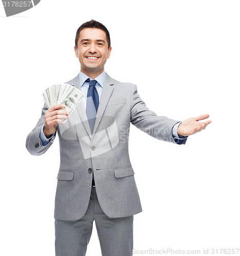 Image of smiling businessman with american dollar money