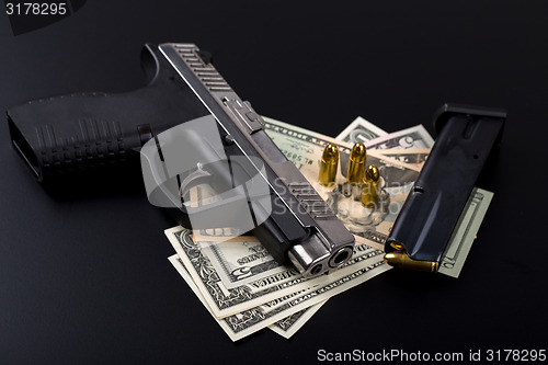 Image of gun with bullet on US dollar banknotes