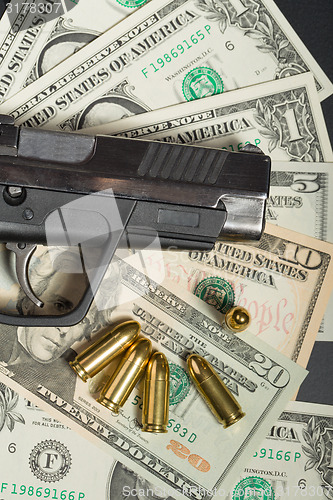 Image of gun with bullet on US dollar banknotes