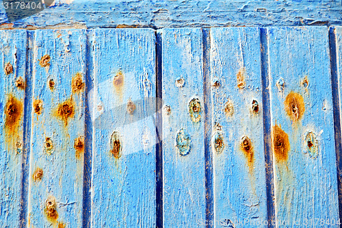 Image of stripped paint in the blue wood red