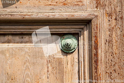 Image of   knocker in a  door curch  closed  lombardy italy  varese lonat