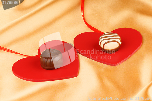 Image of Two chocolate candies and hearts