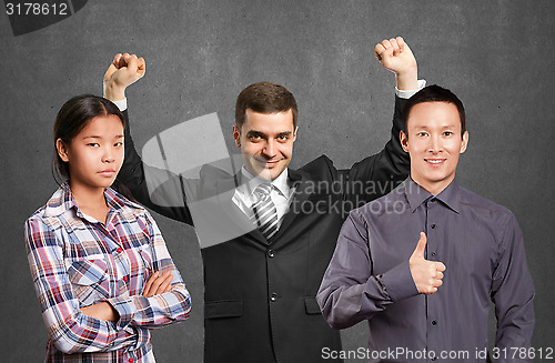 Image of Asian team and businessman with hands up