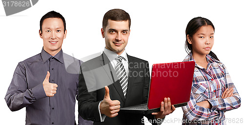 Image of Asian team and male in suit with laptop in his hands