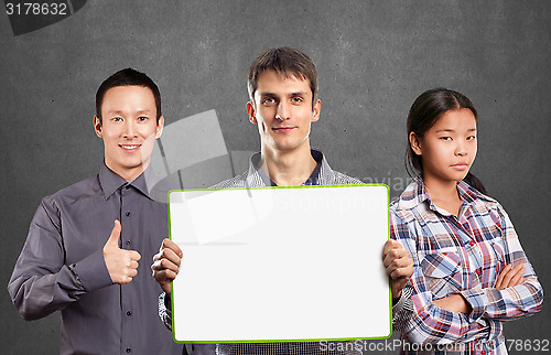 Image of Asian team and male with write board in his hands