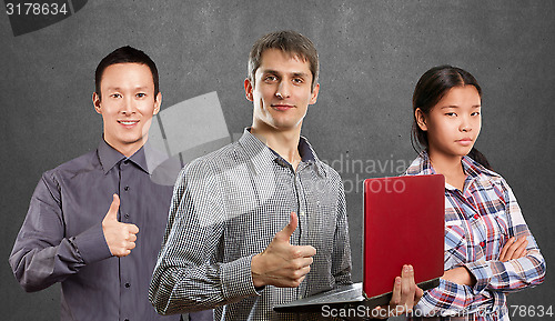 Image of Asian team and man with laptop in his hands and woman