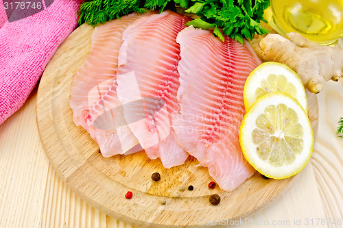 Image of Tilapia with oil and lemon on board
