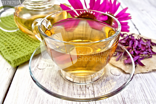 Image of Tea Echinacea in glass cup on board with napkin