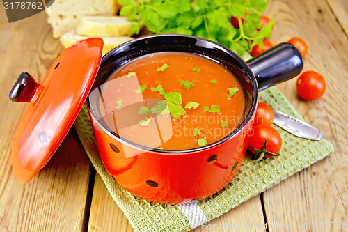 Image of Soup tomato in red ware on board