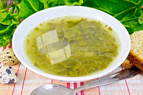 Image of Soup of greenery on linen fabric