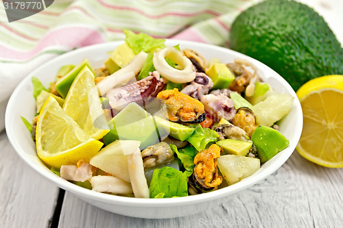 Image of Salad seafood and lemon on white board