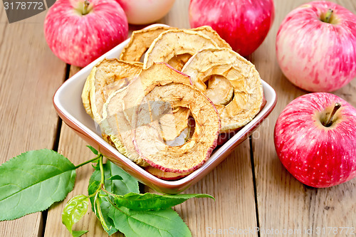 Image of Apples fresh and dried in bowl on board with sheet