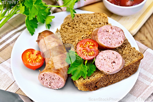 Image of Sausages fried with bread and tomato in plate