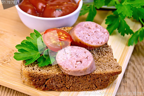 Image of Sausages fried on bread with tomato and sauce