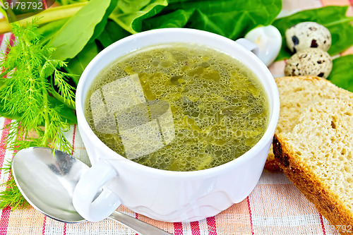 Image of Soup of greenery with bread on cloth