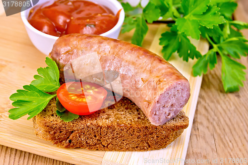 Image of Sausages fried on bread with tomato