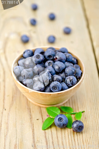 Image of Blueberries in wooden bowl on board