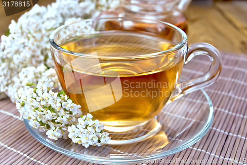 Image of Tea with yarrow in cup on bamboo napkin