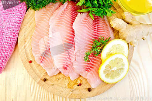 Image of Tilapia with ginger and lemon on board
