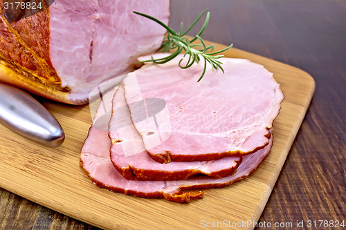 Image of Ham smoked with rosemary on dark board