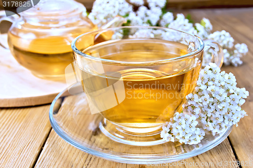 Image of Tea with yarrow in cup on board