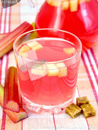 Image of Compote from rhubarb in glassful and pitcher on linen tablecloth