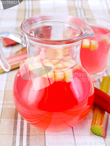 Image of Compote from rhubarb in jar and glassful on tablecloth