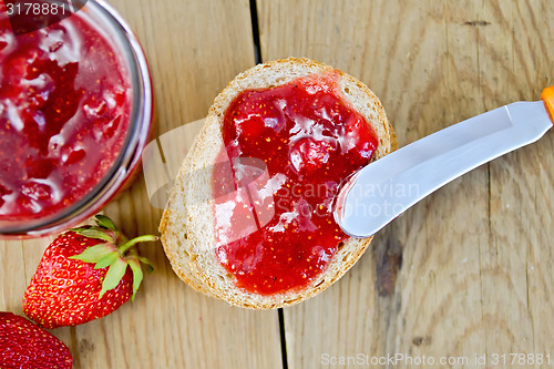 Image of Bread with strawberry jam and berries on board