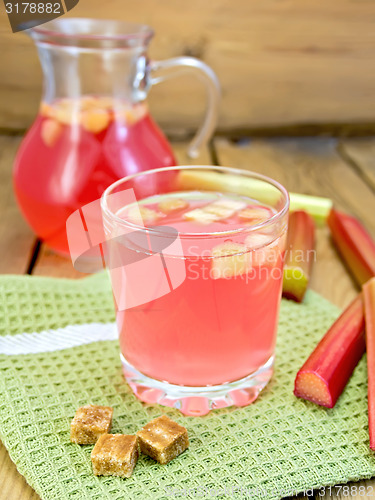 Image of Compote from rhubarb in glassful and jug with sugar on board