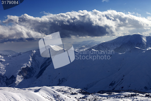 Image of Winter mountains at evening and sunlight clouds