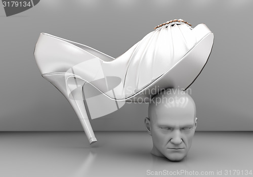 Image of Man\'s head under a female heel 