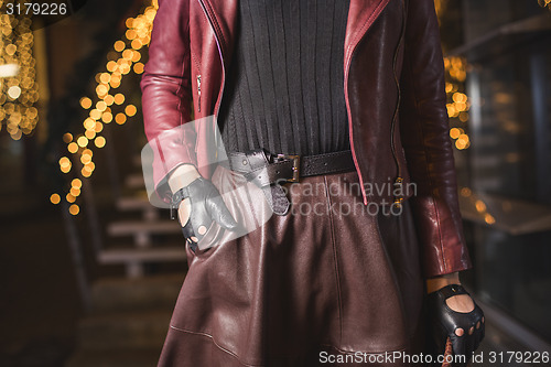 Image of Woman with leather belt and gloves fashion look