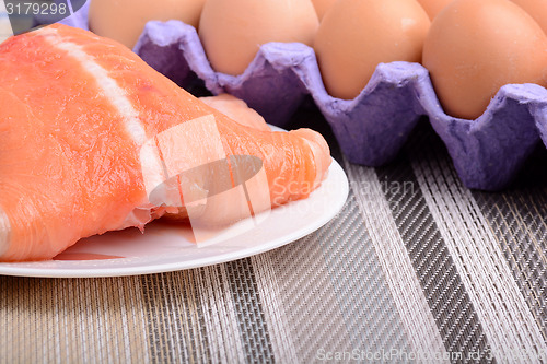 Image of Fresh uncooked red fish fillet slices and eggs