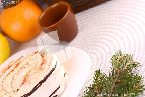 Image of sweet cake on white plate and fruits