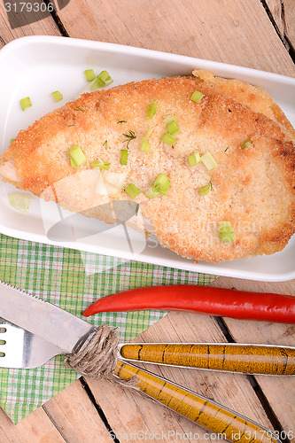 Image of Fresh meat on white plate with red pepper