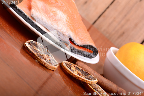 Image of Slice of red fish salmon with fruits and cinnamon