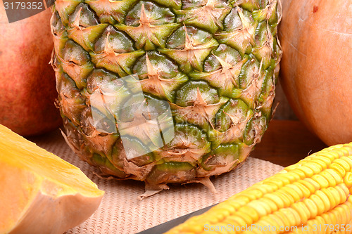 Image of fresh pineapple with corn and orange