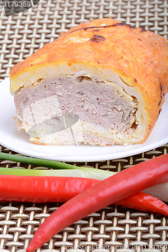 Image of Fresh meat on white plate with red pepper