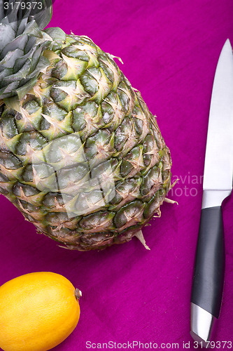 Image of fresh pineapple with corn and lemon